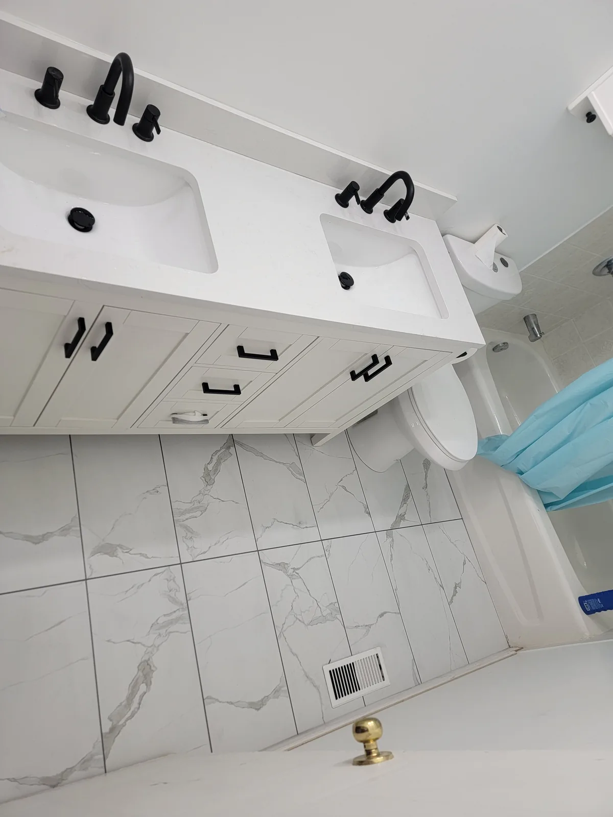 Bathroom vanity with white cabinetry and tile floor