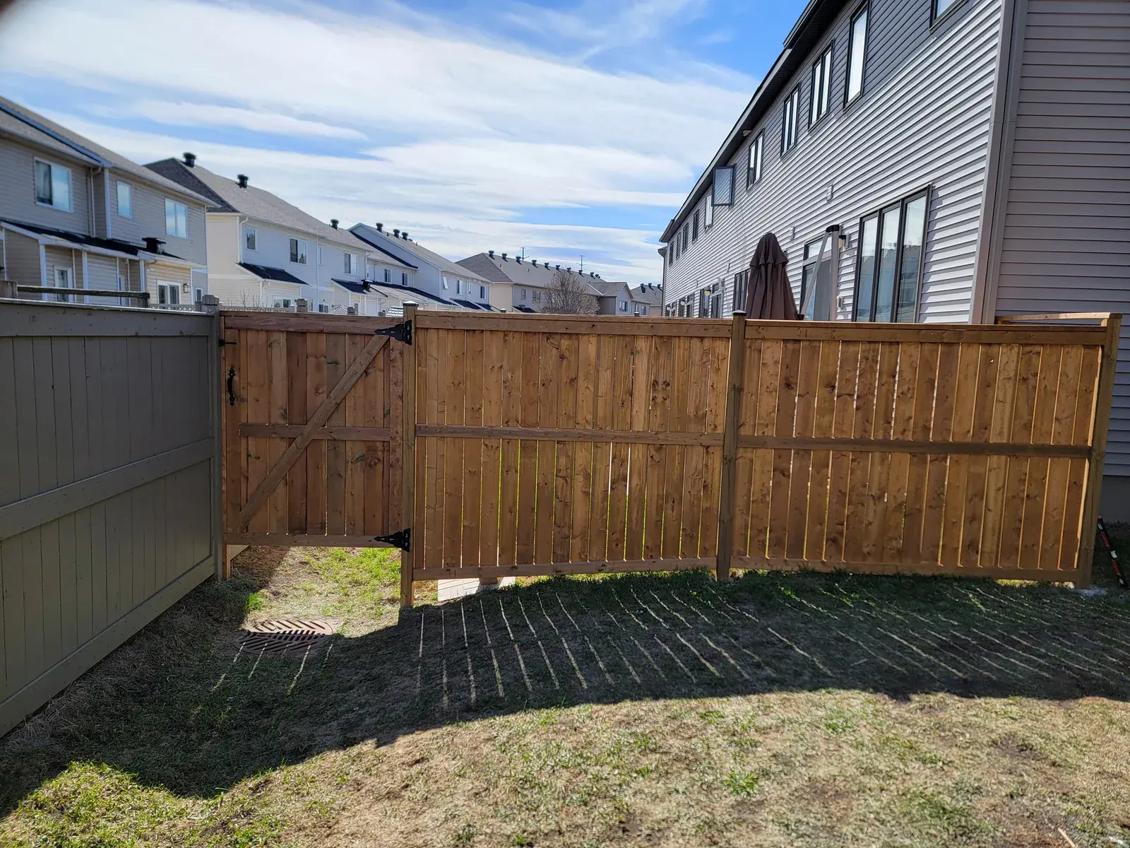Wood fence along a backyard side yard