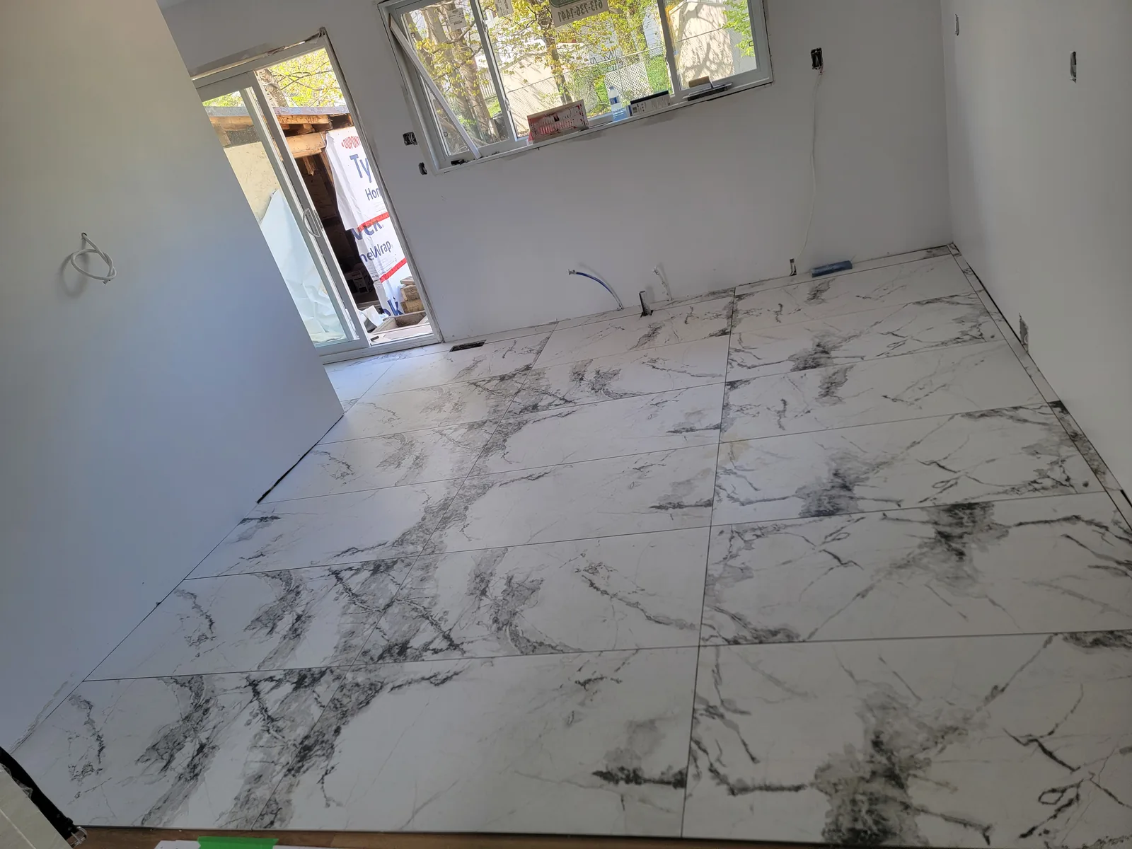Large-format marble-look floor tile in an interior room