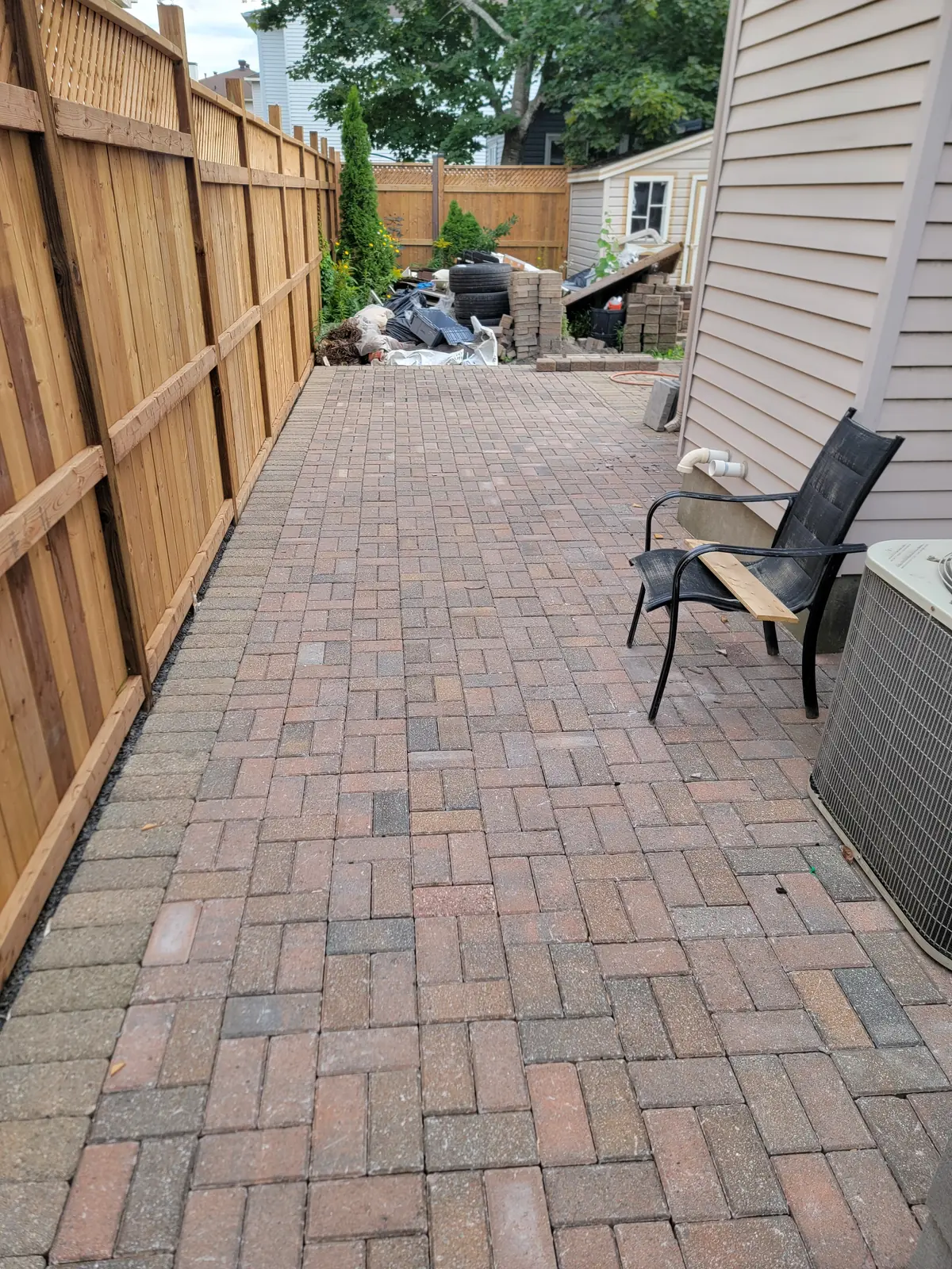 Finished interlock surface along a fenced side yard