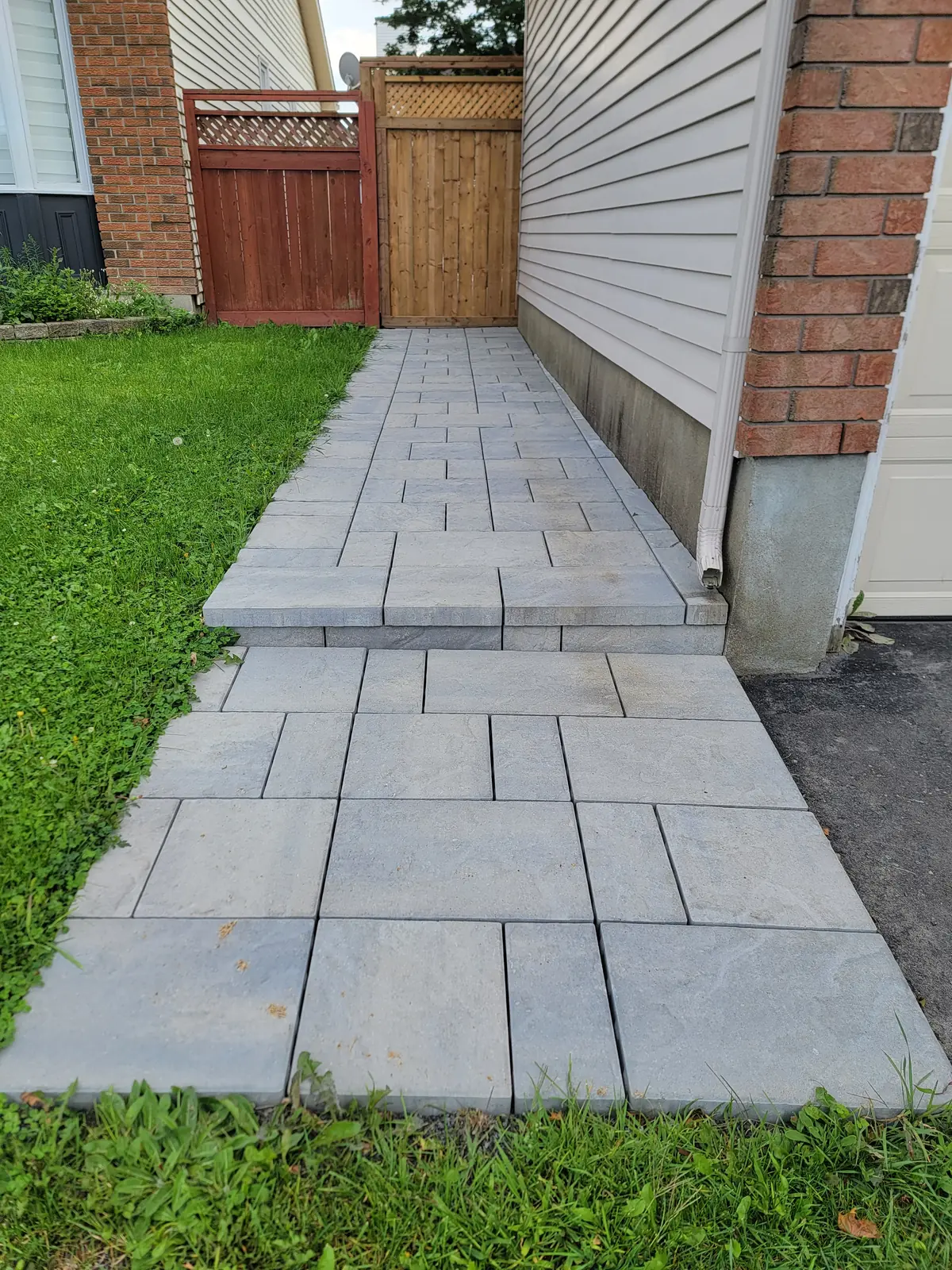 Grey interlock walkway with exterior step detail
