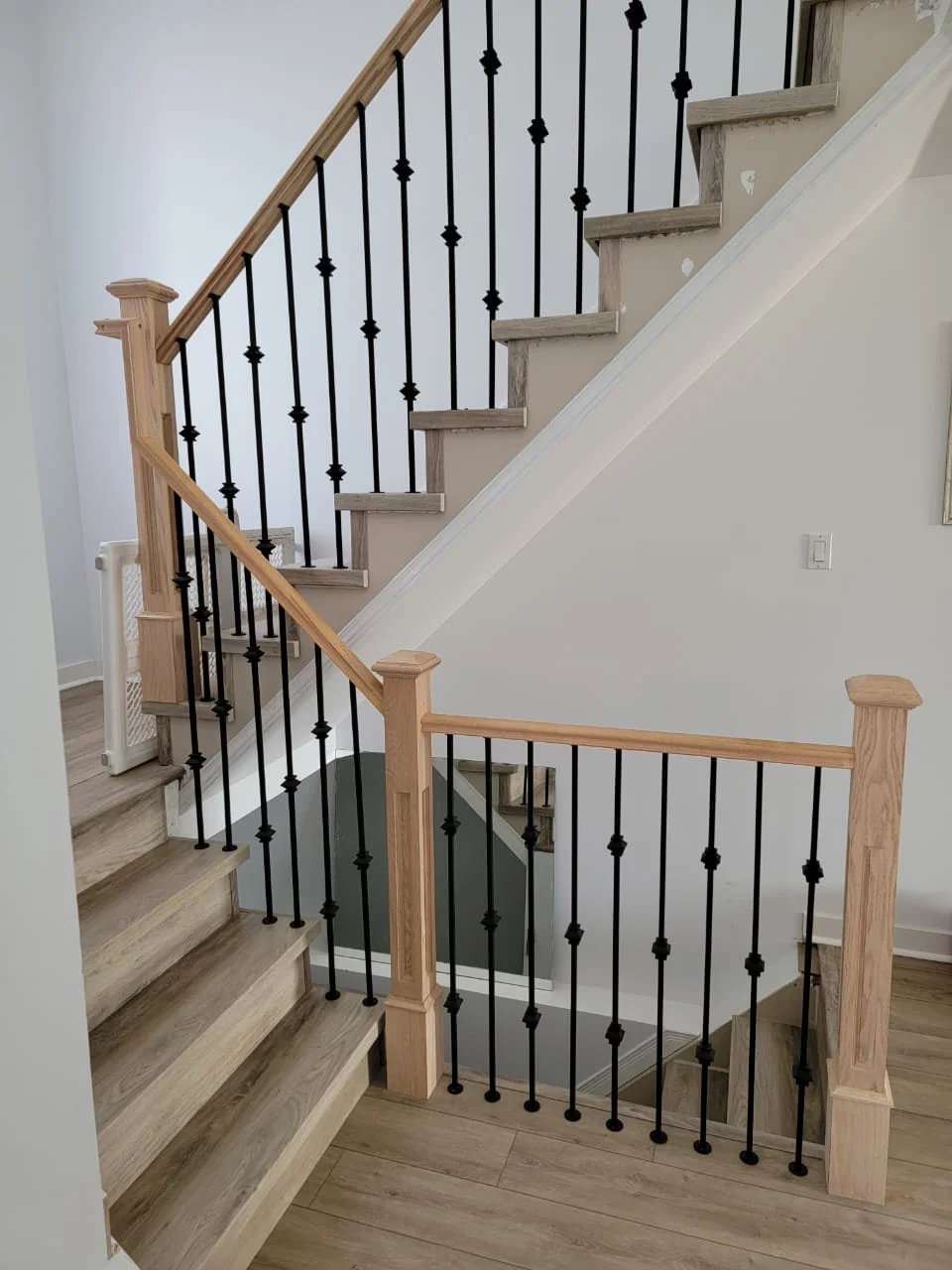 Wood handrails and black metal balusters